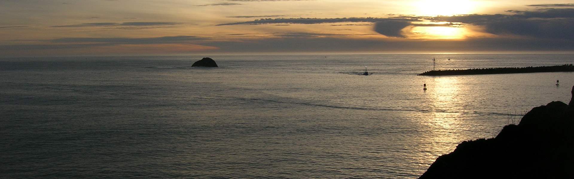 Sunset over Crescent City jetty viewed from Whalers Island